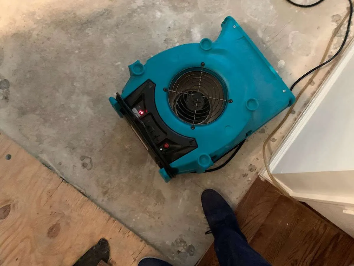Air mover drying subfloor during Commercial Water Damage Restoration in Mundelein